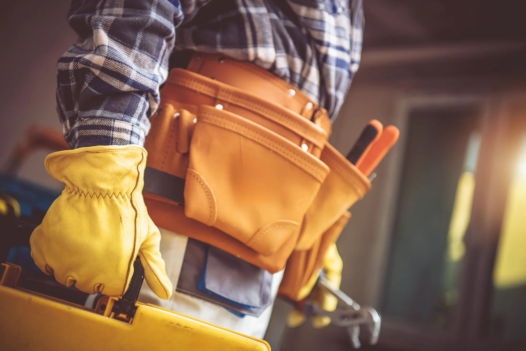 handyman wearing yellow gloves for work