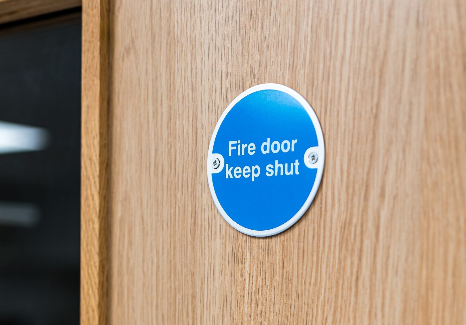 Close-up of a typical Fire Door Keep Shut sign seen on an interior door Close-up of a typical Fire Door Keep Shut sign seen on an interior door